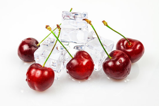Sweet cherries with ice cubes, yes against a white background