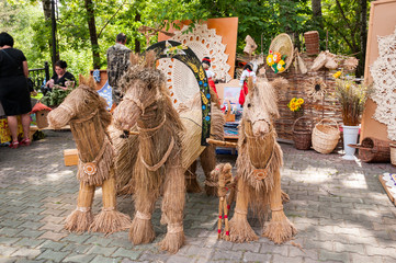 Russia, Khabarovsk, August 18, 2018: Folk handicrafts, horses from straw at the harvest festival
