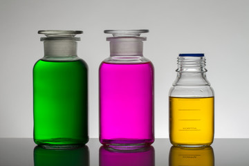 Liquid in laboratory bottles. Scientific biochemical laboratory. Colorful liquid.