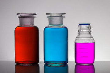 Liquid in laboratory bottles. Scientific biochemical laboratory. Colorful liquid.