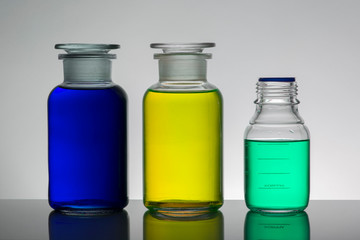 Liquid in laboratory bottles. Scientific biochemical laboratory. Colorful liquid.