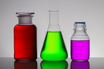 Liquid in laboratory bottles. Scientific biochemical laboratory. Colorful liquid.