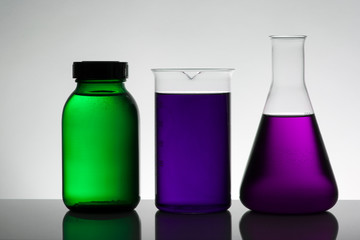 Liquid in laboratory bottles. Scientific biochemical laboratory. Colorful liquid.