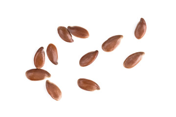 Small group of linseeds or flax seeds spread out and isolated on white background - obrazy, fototapety, plakaty