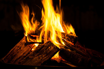 Hot burning fire flames generating heat in dark cold winter night