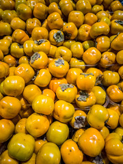 Pile  of ripe persimmons on Mediterranean  market