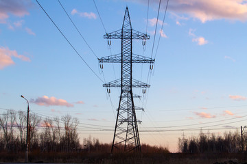 High-voltage power lines at sunset