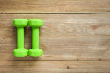 dumbbells on wooden background
