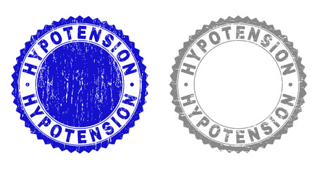 Grunge HYPOTENSION stamp seals isolated on a white background. Rosette seals with distress texture in blue and gray colors. Vector rubber stamp imitation of HYPOTENSION caption inside round rosette.
