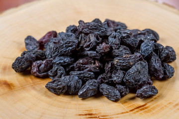 Blue raisins on a wooden background