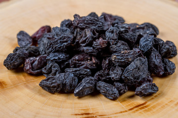 Blue raisins on a wooden background