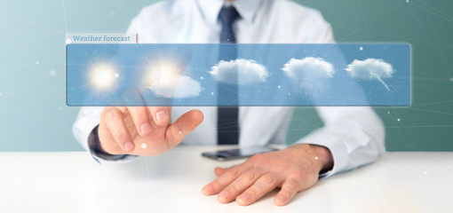 Obraz na płótnie Canvas Businessman holding a Weather Forecast widget 3d rendering