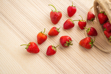 Fresh organic red ripe Strawberry fruit on wood background closeup