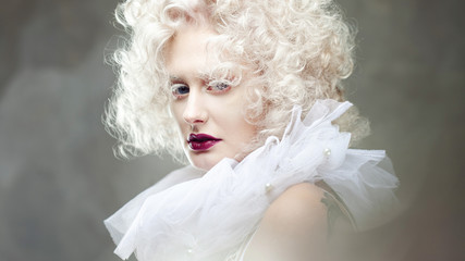 Young attractive woman with platinum blonde and purple lipstick