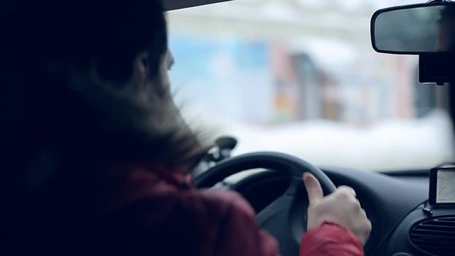 A man gets into the car and turns on the navigator on the smartphone