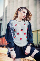 Outdoor portrait of cute grunge (rock) girl at the railroad