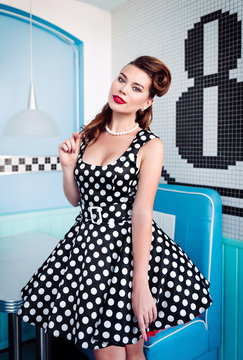 Pin up style portrait of pretty young girl in dress. Retro (vintage)