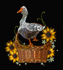 Embroidery goose in a wicker basket with sunflowers. Template for clothes, textiles and t-shirt design