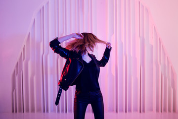 Beautiful girl dancing in retro wave on the neon light
