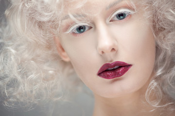 Young attractive woman with platinum blonde and purple lipstick