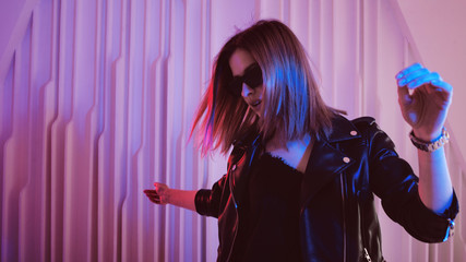 Beautiful girl dancing in retro wave on the neon light