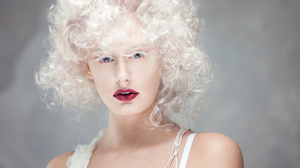 Young attractive woman with platinum blonde and purple lipstick