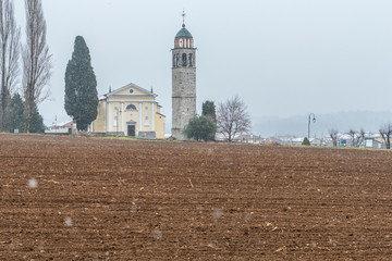 Snow time. Montegnacco, the first snowflakes carried by the wind. Among historic mansions and ancient churches