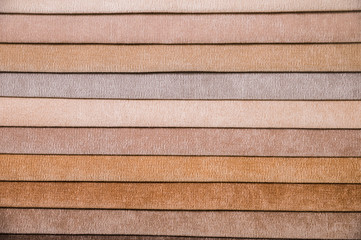 Colorful and bright fabric samples of furniture and clothing upholstery. Close-up of a palette of textile abstract stripes of different colors