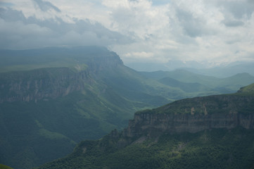 Fototapeta premium Dramatic landscape of a green valley at the foot of the Inal Plateau in the North Caucasus