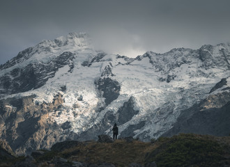 Hiker in front of a snowy mountain
