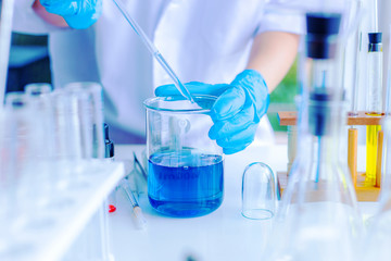 The scientist test new product by test tube in health sciences, life sciences and chemistry experiments.