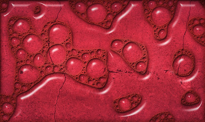 Abstract background in red color with liquid bubbles over textured cement bottom 