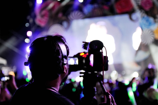 Cameraman recording concert event at night party concert,Recording night party concert  with video camera,Selective focus