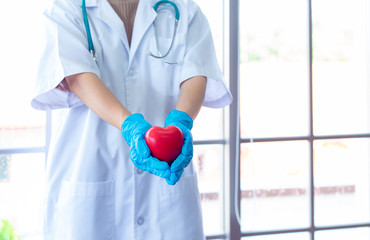 Surgeon holding a heart shape