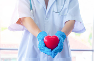 Surgeon holding a heart shape