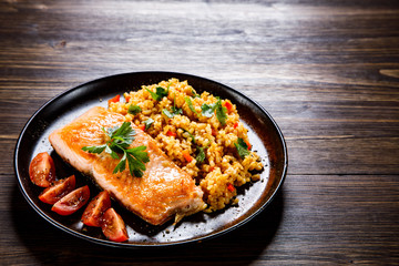 Roast salmon with groats and vegetables