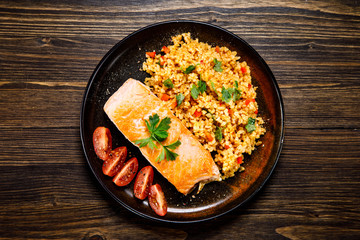 Roast salmon with groats and vegetables