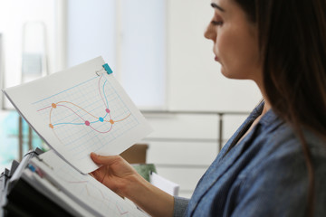 Young woman working with documents in office