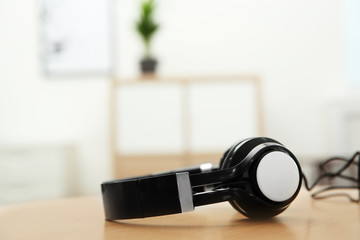 Fototapeta na wymiar Stylish headphones on table indoors. Space for text