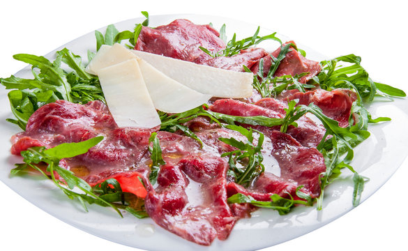 Veal carpaccio with salad and Parmesan on white background