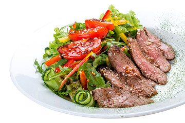 Salad with dried beef and tomatoes on white background