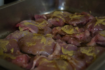 fresh raw chicken meat with mustard in a trey, cooking