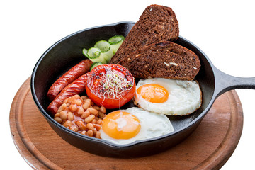 Breakfast in a pan on a white background. Scrambled eggs with beans, toast and sausages.