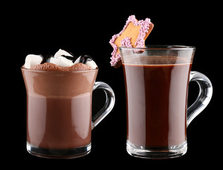 Cocoa with marshmallow, cookies and chocolate syrup in a Cup on a dark background