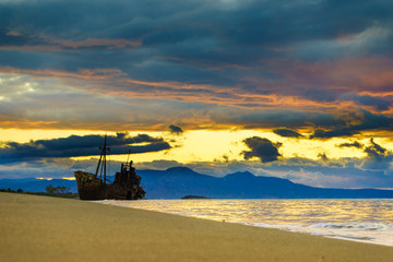 Rusty broken shipwreck on sea shore