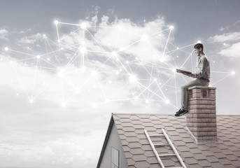 Man on brick roof reading book and concept of social connection