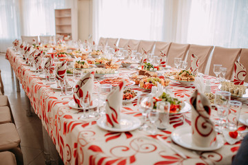 Festive table decoration. White and red color decorated table.