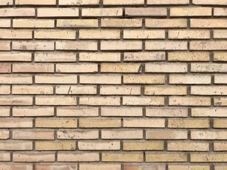Vintage and old yellow brick wall with white joints texture background