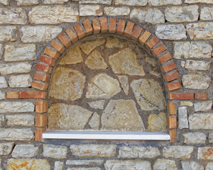 Greece, traditional arched decoration recess on stone wall