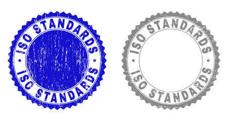 Grunge ISO STANDARDS stamp seals isolated on a white background. Rosette seals with grunge texture in blue and gray colors. Vector rubber stamp imitation of ISO STANDARDS tag inside round rosette.
